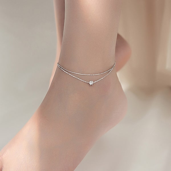 Woman wearing a delicate silver crystal anklet