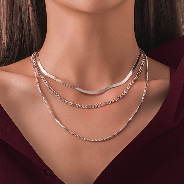 Woman wearing a 4.5mm silver figaro chain necklace