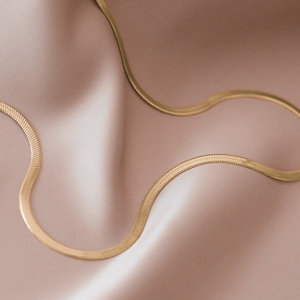 Detail photo of a waterproof 4mm gold herringbone chain necklace