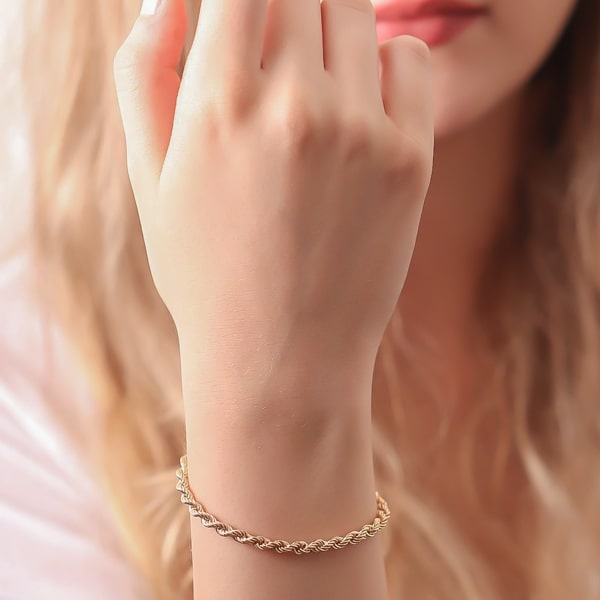 4mm gold rope chain bracelet displayed on a woman's wrist