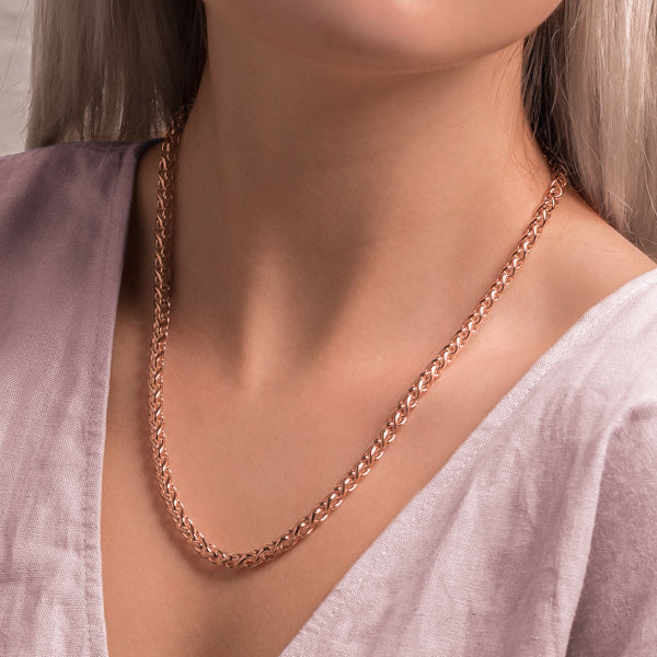 Woman wearing a 5mm rose gold wheat chain necklace