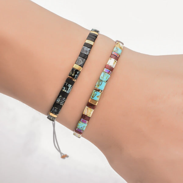 Woman wearing a black and gold square bead bracelet