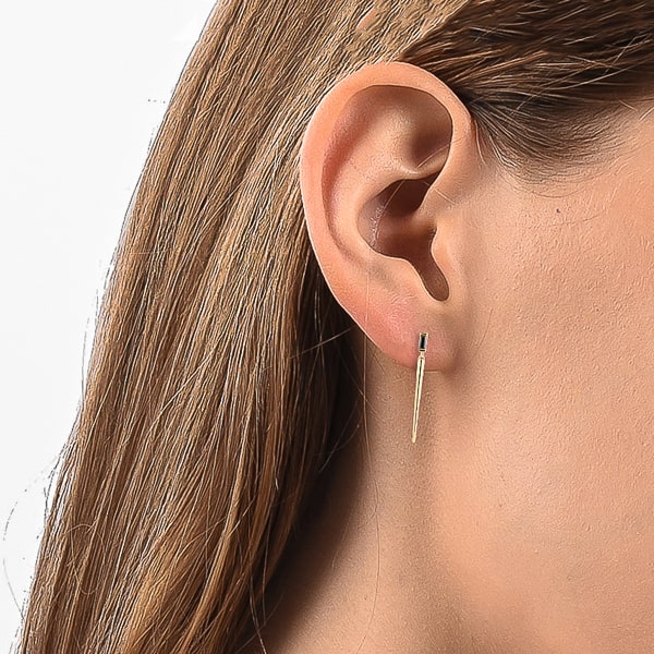 Woman wearing black crystal drop spike stud earrings