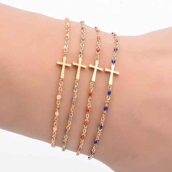 Woman wearing a gold cross bracelet with blue beads