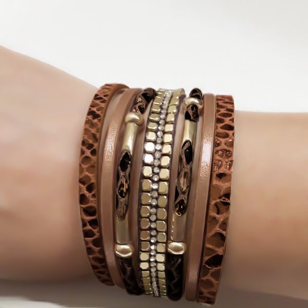 Woman wearing a brown and gold snakeskin leather cuff bracelet on her wrist