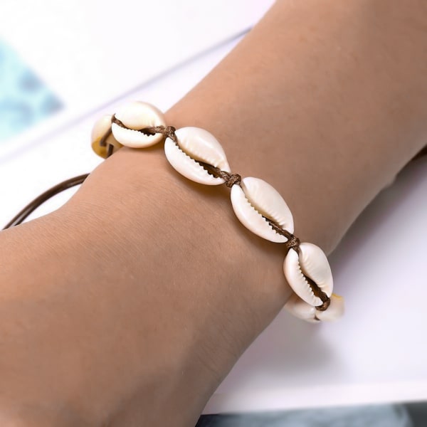 Woman wearing a cowrie shell bracelet