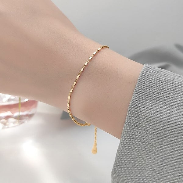 Dainty gold vermeil chain bracelet on woman's wrist