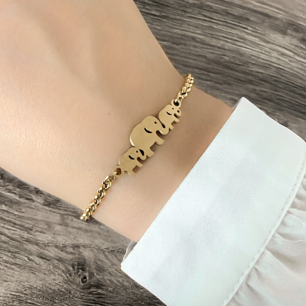 Woman wearing a gold elephant family bracelet