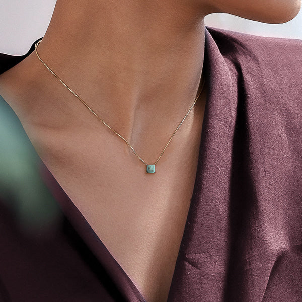 Woman wearing a gold Green Tourmaline necklace