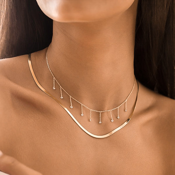 Woman wearing a 3mm gold herringbone chain necklace
