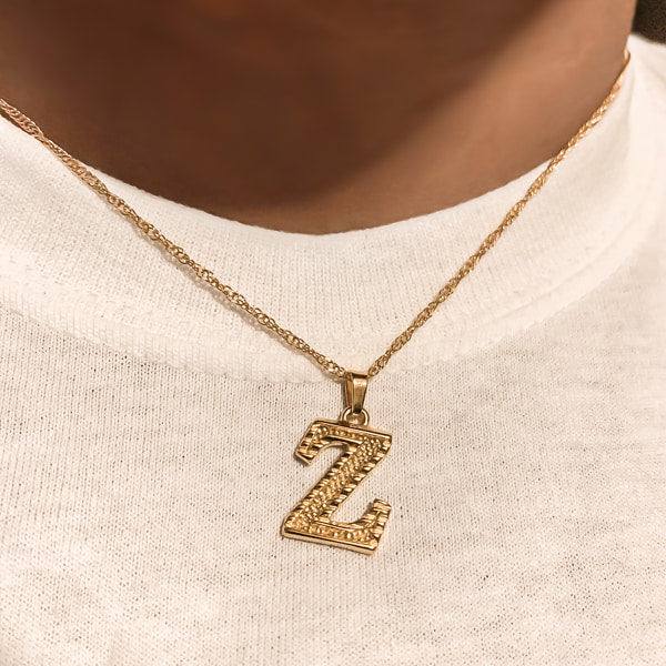 Woman wearing a gold initial letter pendant necklace