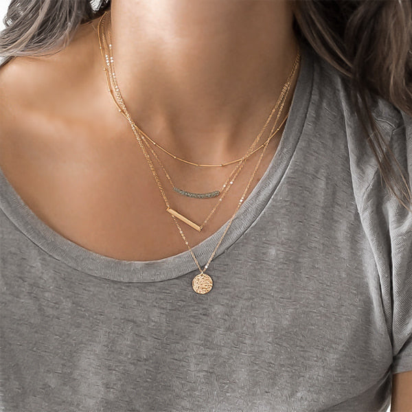 Woman wearing gold layered necklaces