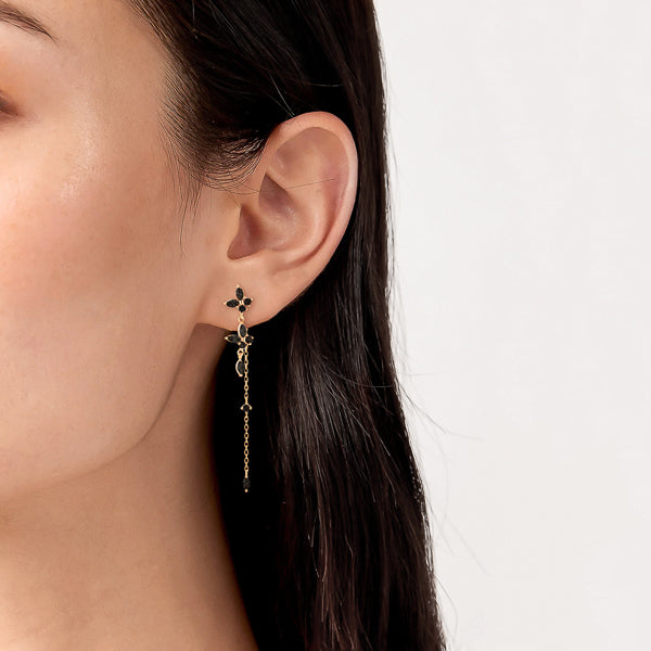 Gold black butterfly drop chain earrings on woman