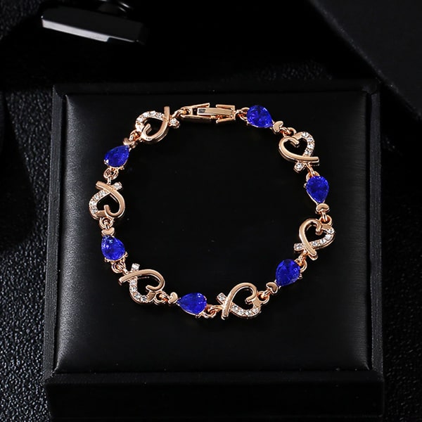 Gold heart chain bracelet with blue crystals details