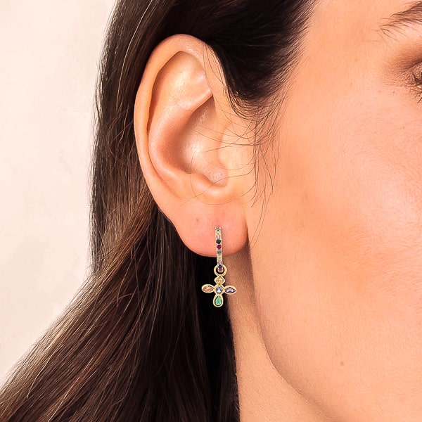 Woman wearing gold colorful crystal cross c hoop earrings