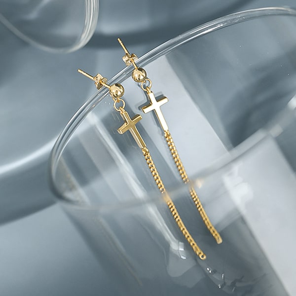 Gold cross drop chain earrings detail