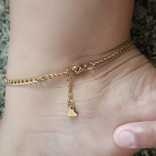 Gold curb chain anklet displayed on a womans ankle