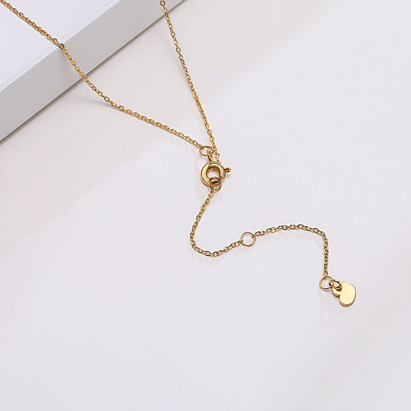 Gold sideways cross necklace display