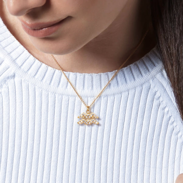Woman wearing a gold vermeil Aquarius necklace