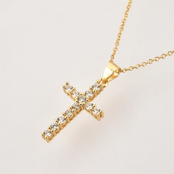 White crystal cross on a golden necklace details