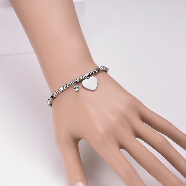 Woman wearing a heart bracelet on her wrist