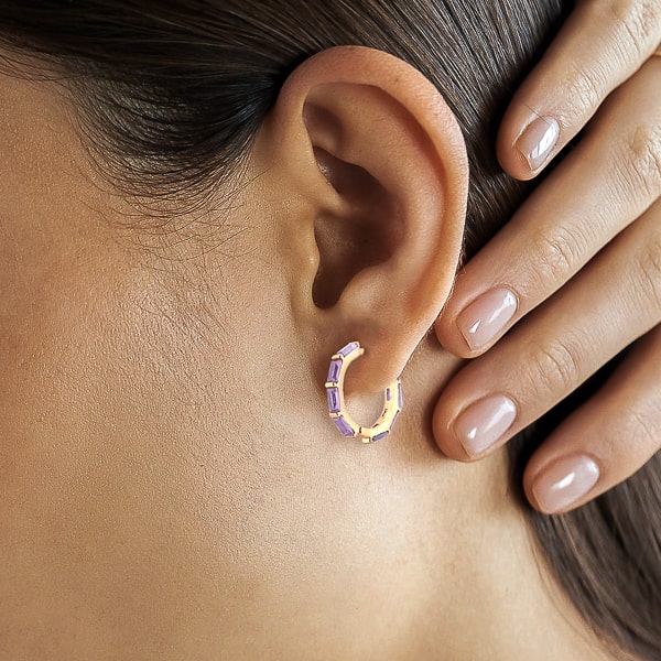 Woman wearing lavender baguette-cut crystal hoop earrings