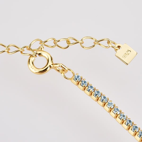 Details of the gold tennis choker necklace with light blue cubic zirconia stones