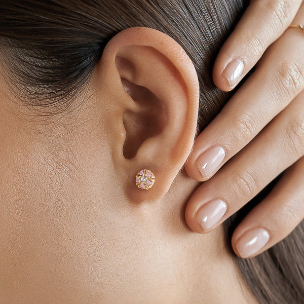 Light pink crystal floral stud earrings on woman
