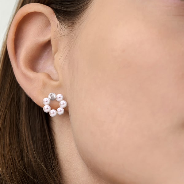 Woman wearing pearl circle stud earrings