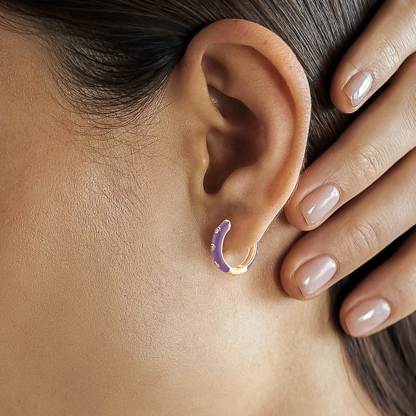 Woman wearing purple enamel mini hoop earrings