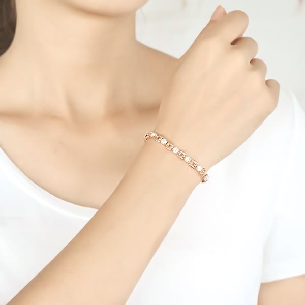Woman wearing a clear and rose gold crystal bracelet