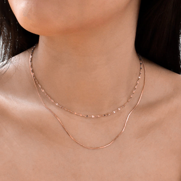 Woman wearing a rose gold lace chain necklace