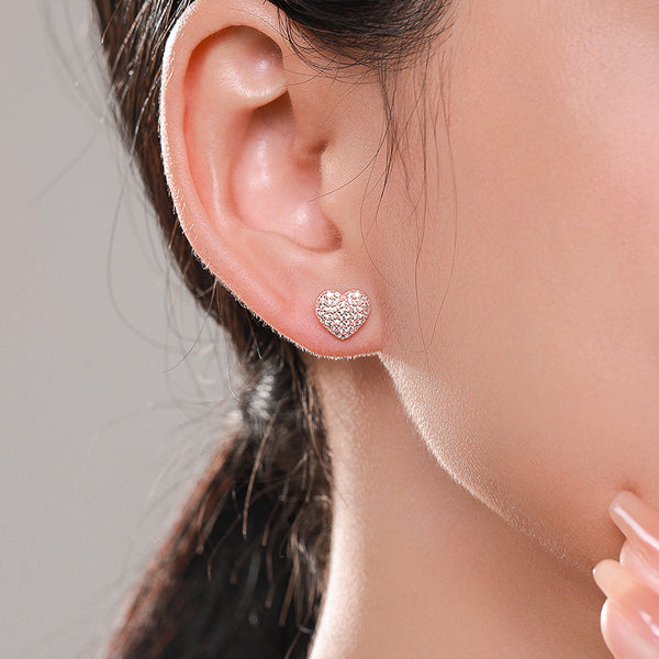 Rose gold pavé crystal heart stud earrings on model