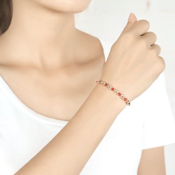 Woman wearing a red and rose gold crystal bracelet