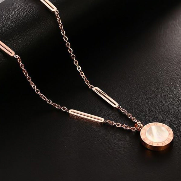 Rose gold Roman numeral coin necklace display