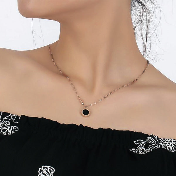 Woman wearing a rose gold Roman numeral coin necklace