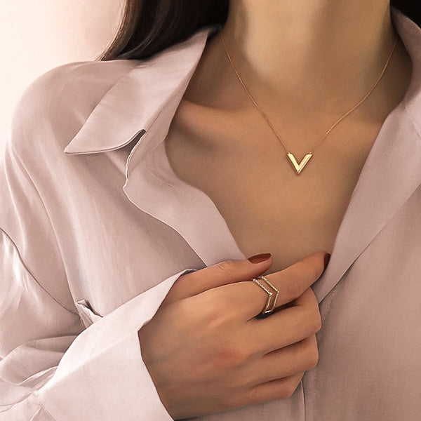 Woman wearing a rose gold V necklace