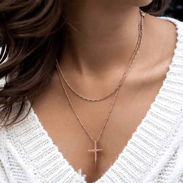 Woman wearing a rose gold cross necklace