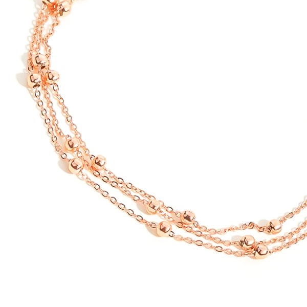 Rose gold layered bead ankle bracelet detailed close up