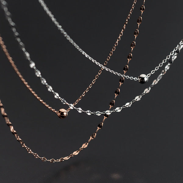 Rose gold layered choker necklace display