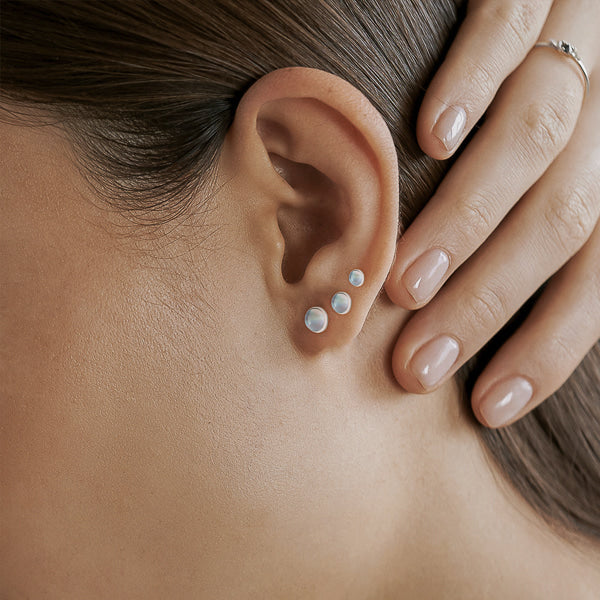 Woman wearing moonstone stud earrings
