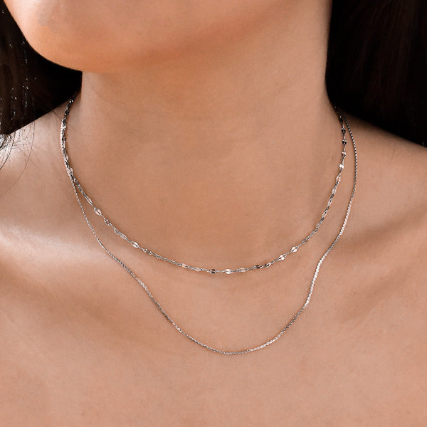 Woman wearing a silver lace chain necklace