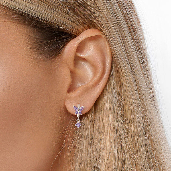 Silver and purple crystal butterfly huggie hoop earrings on model