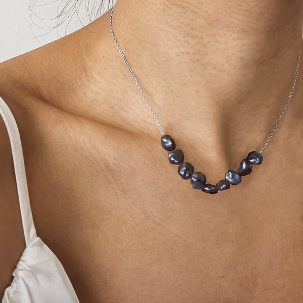 Silver black baroque freshwater pearls necklace on a woman's neck
