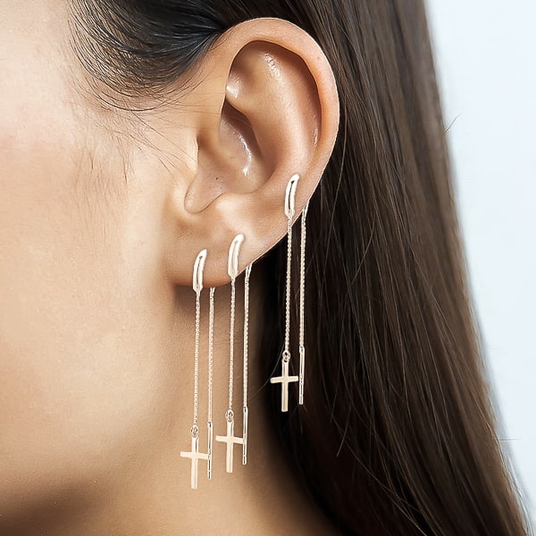 Woman wearing silver cross threader earrings