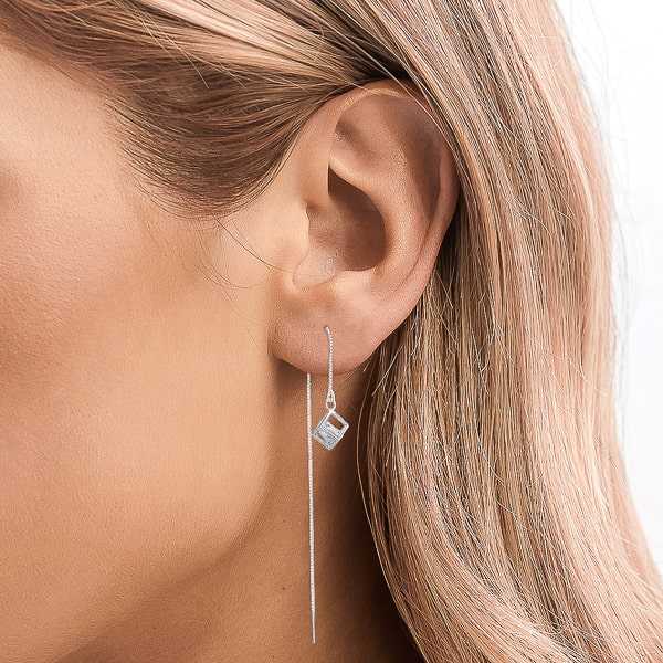 Woman wearing silver crystal cube threader earrings