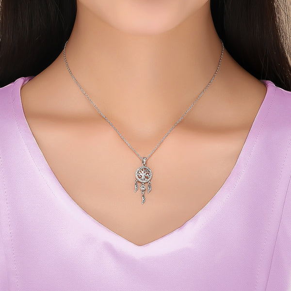 Woman wearing a silver crystal dreamcatcher pendant necklace