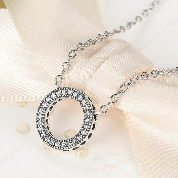 Round crystal ring on a silver necklace display