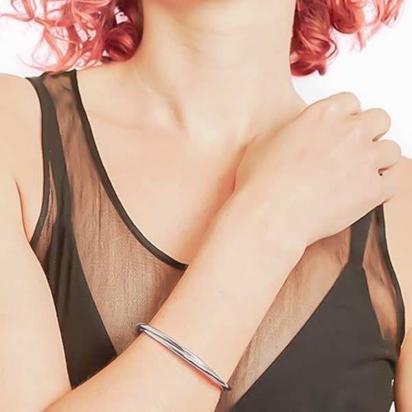 Silver dual cuff bracelet on woman's wrist