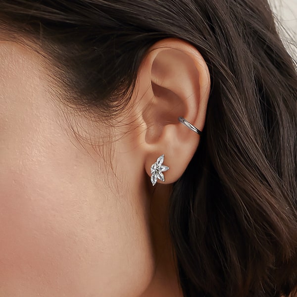 Woman wearing silver flower crystal stud earrings